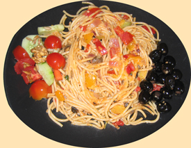 Spaghetti on plate with side dishes